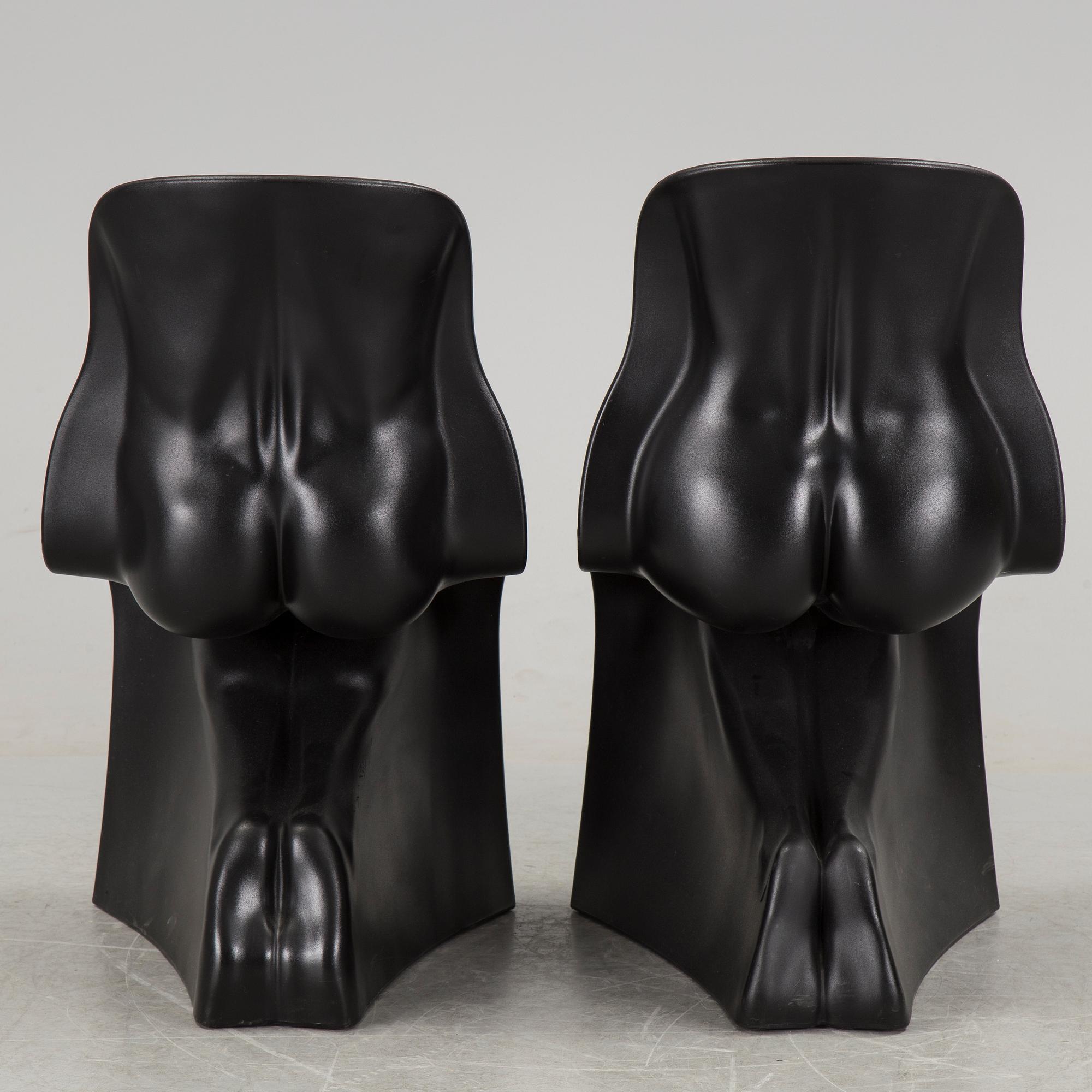 a pair of Italian black plastic chairs designed by Fabio Novembre "Him" and "Her" from the late 20th Century.