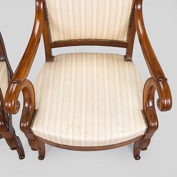A pair of French open-arm chairs, first half of the 19th century.