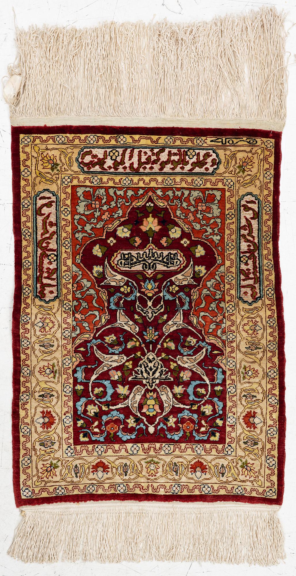 A silk and metal Hereke rug, West Anatolia, c. 58 x 39 cm.