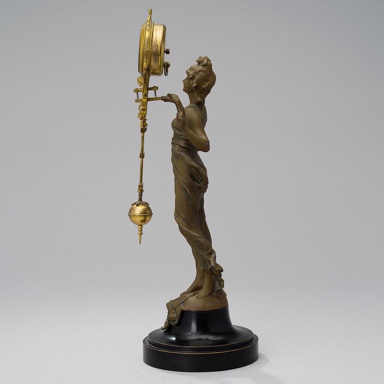 A 1930s Junghans swinger clock with girl sculpture.