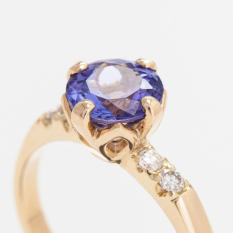 A 14K gold ring, with a tanzanite and diamonds.