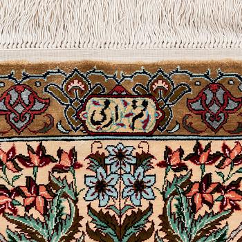 A silk Qum rug, Central Persia, signed, c. 135 x 208 cm.