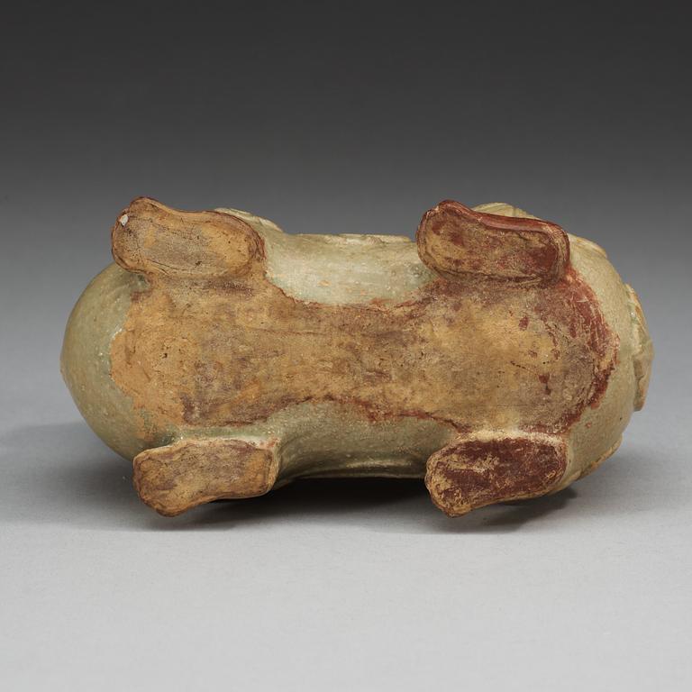 A pale celadon glazed figure of a mythological beast, Six dynasties (222-589).