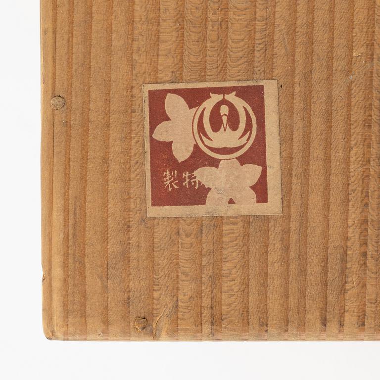 A Japanese wooden box with 15 small dolls, 20th Century.
