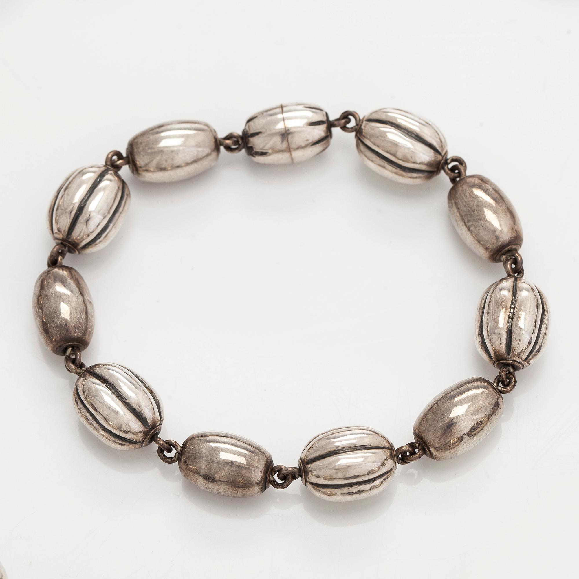Kalevala Koru, a set of sterling silver "Halikko treasure" necklace, bracelet, ring and earrings. Helsinki 1994.
