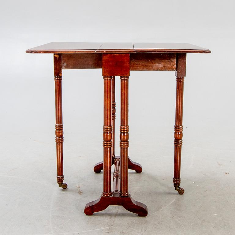 A 20th century English mahogany folding table.