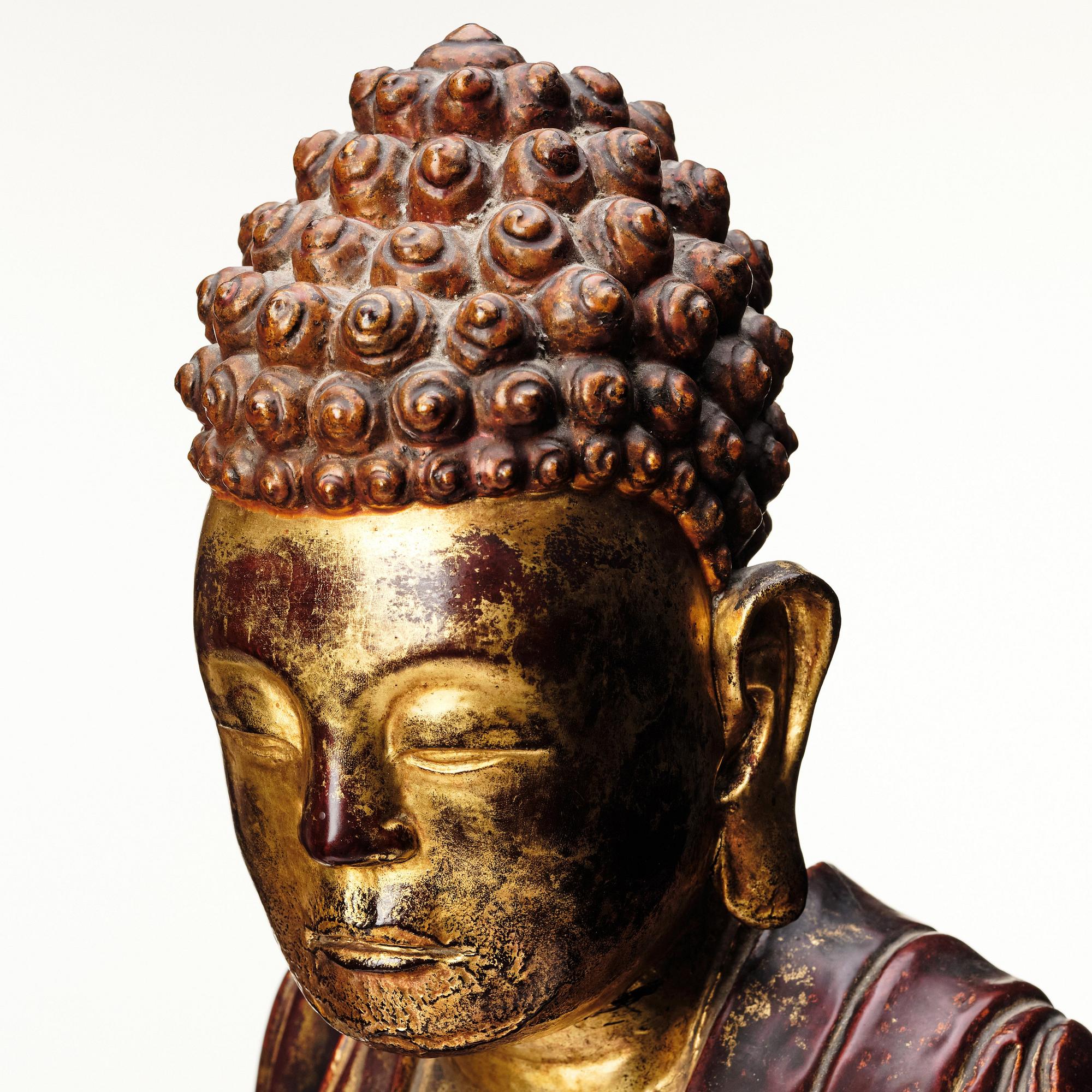 A large gilt and lacquered figure of a seated buddha, Qing dynasty, 19th Century.