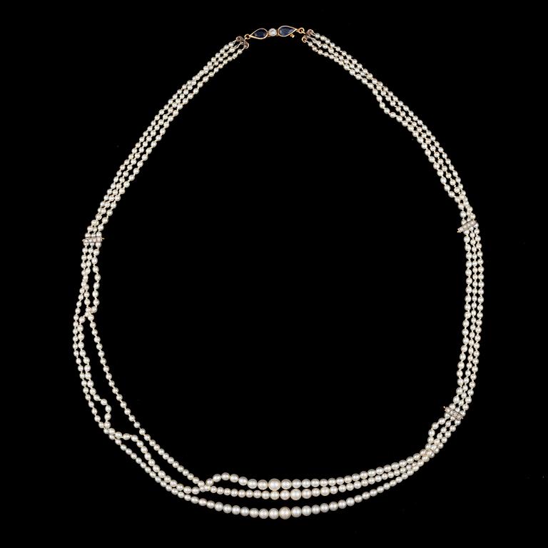 A PEARL NECKLACE, natural saltwater pearls. Clasp in 14K gold with sapphire and diamonds, Helsinki 1954.