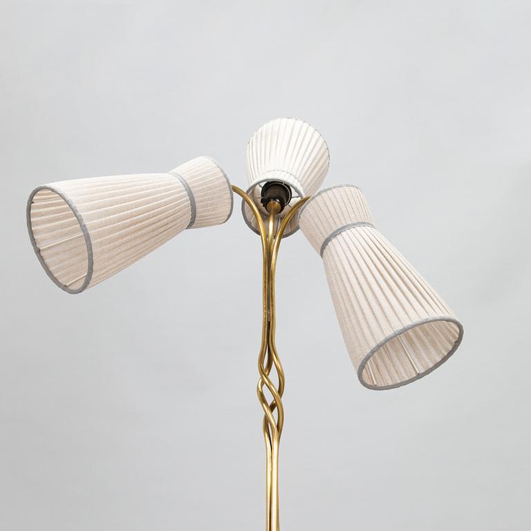 A three-arm floor lamp in brass, mid 20th century.