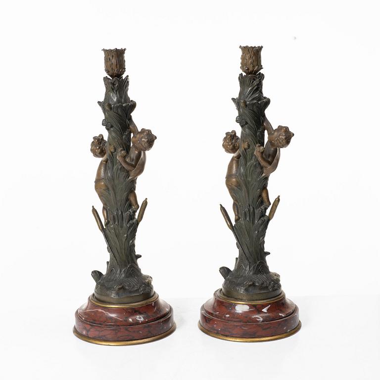 a pair of bronze and marble candle sticks, after a model by Houdon, late 19th century.