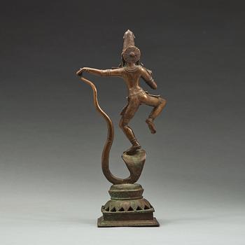 A bronze scupture of Krishna who has konkured the five headed serpant, India, early 20th Century.