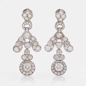 1131. A pair of 18K white gold earrings set with old- and round brilliant-cut diamonds.