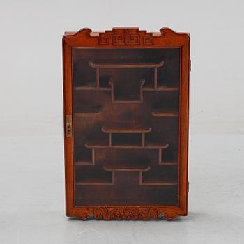 A Chinese hardwood hanging display cabinet, 20th century.