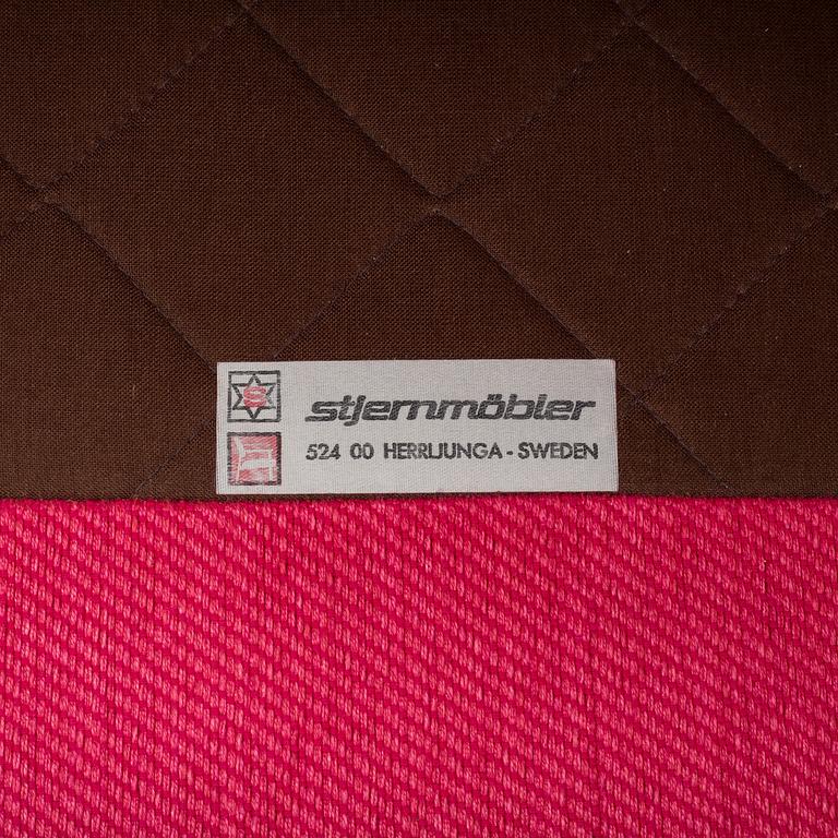 An 'Oxford' model no 3543 easy chair with stool by Ragnar Helsén for Firma Svenskt Tenn.