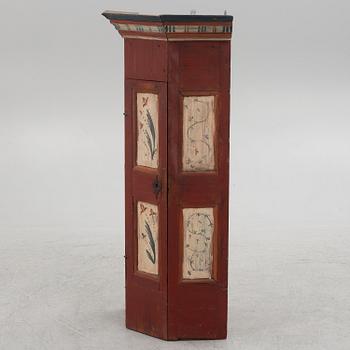 A painted corner cabinet, 19th century.