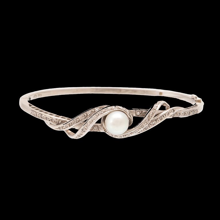 An 18K white gold bracelet with single-cut diamonds and a cultured pearl.