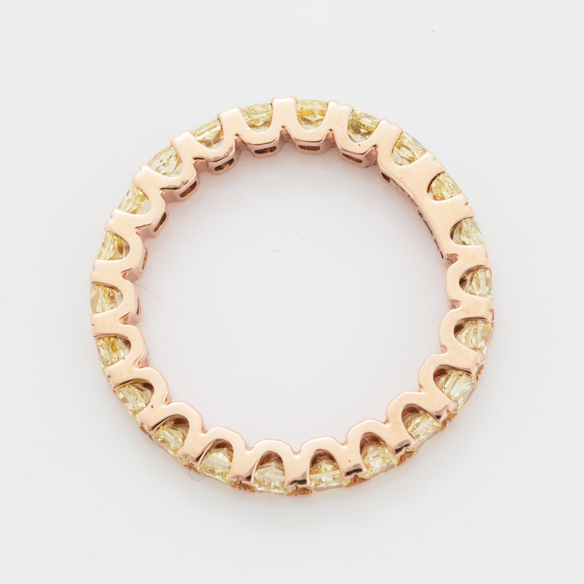 Cushion-cut yellow diamond eternity ring.