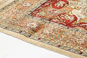 A rug, semi-antique, silke Hereke, signed, ca 184,5 x 118 cm.