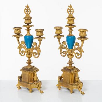 A French Louis XVI-style mantel clock and a pair of candelabra, late 19th Century.