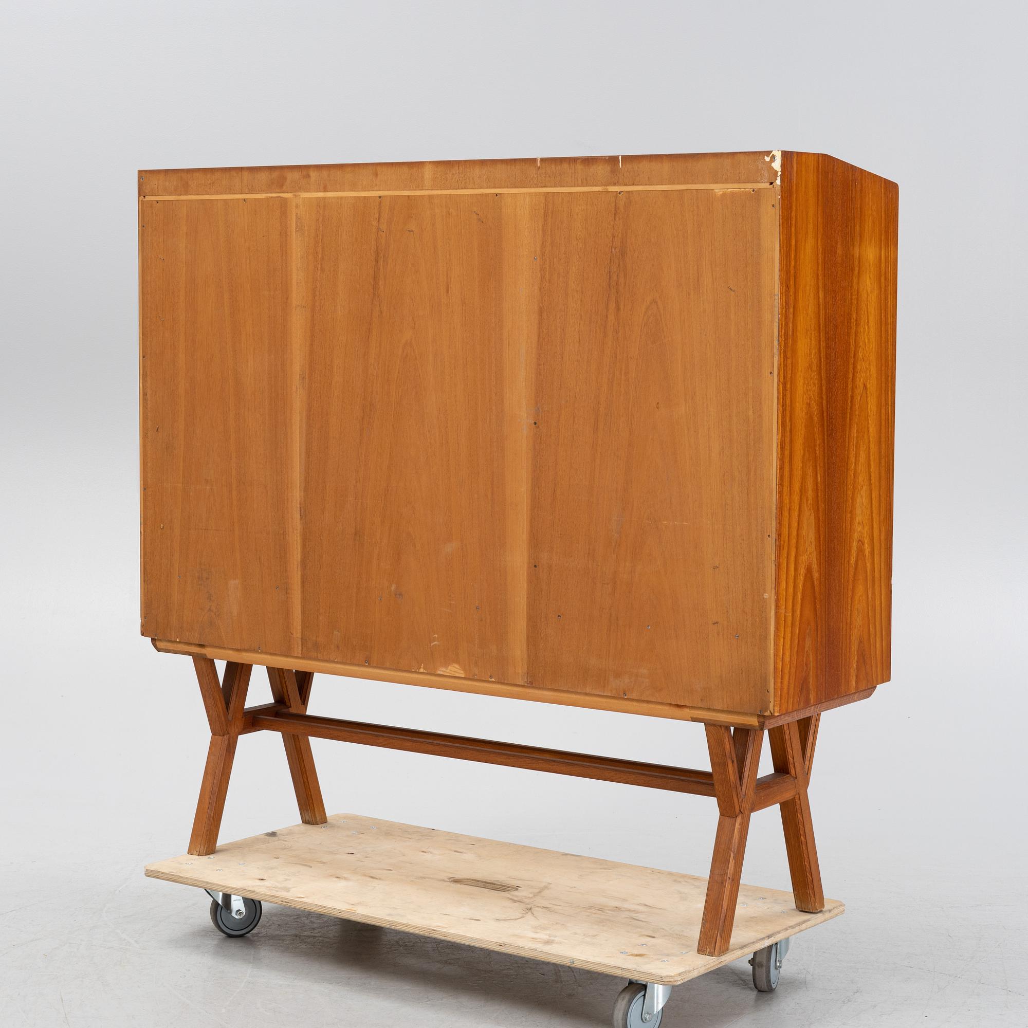 A teak-veneered mid 20th century sideboard.