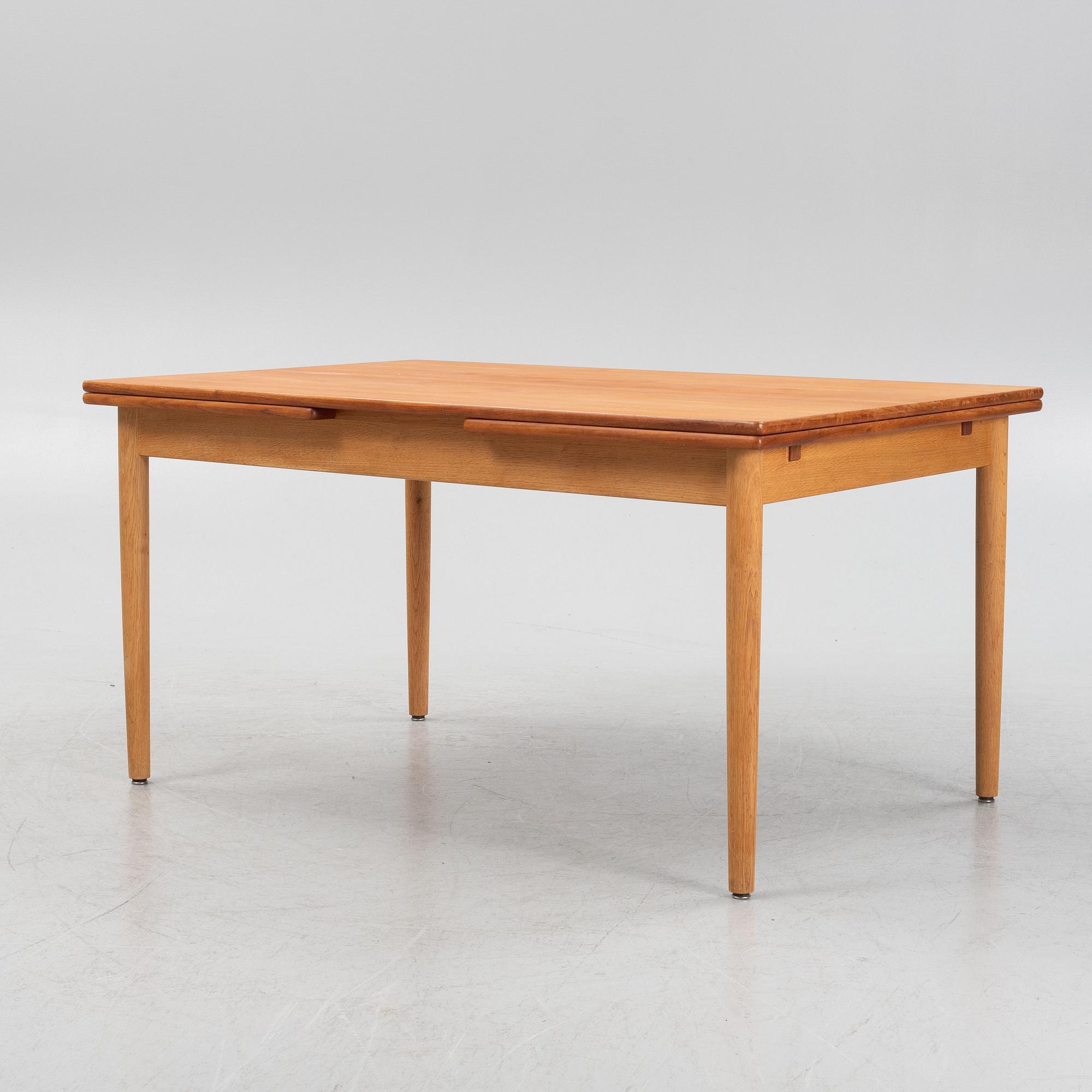 Hans J. Wegner, an oak and teak dinner table for Andreas Tuck. Denmark.