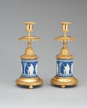 A pair of Victorian Wedgewood and gilt bronze candlesticks.