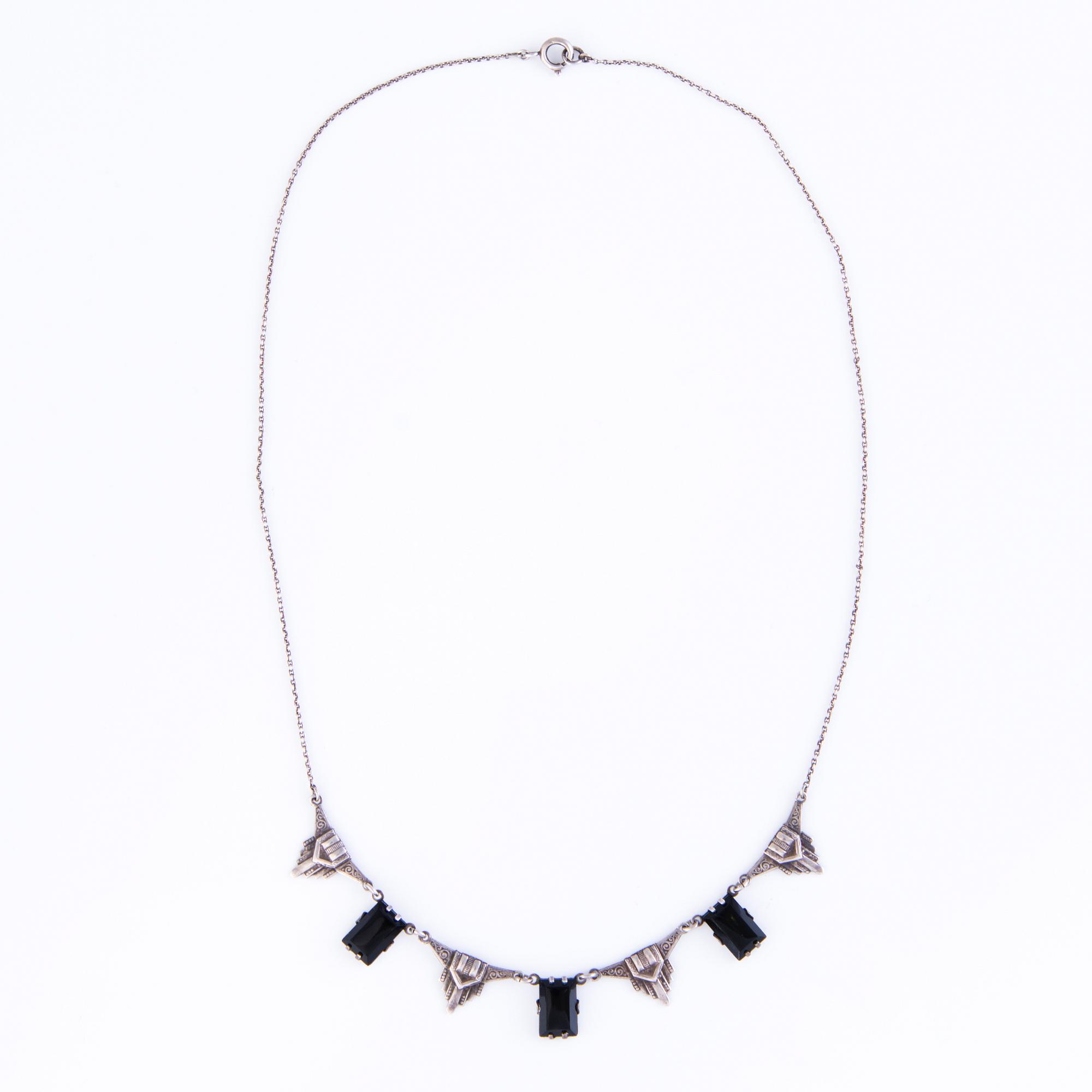 Four Art deco jewelry, ring, pendant necklace and earrings in silver.