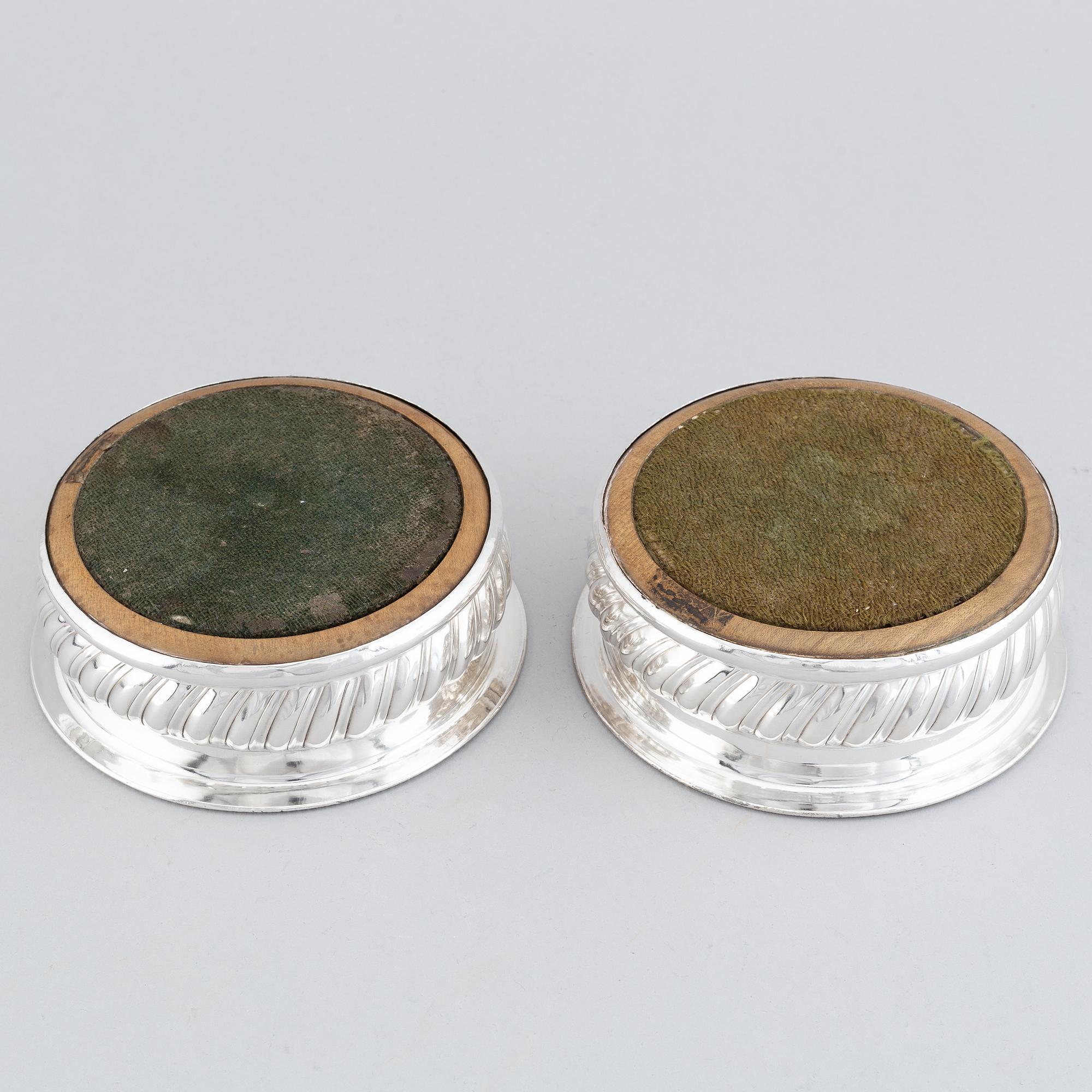 A pair of silver plated coasters.