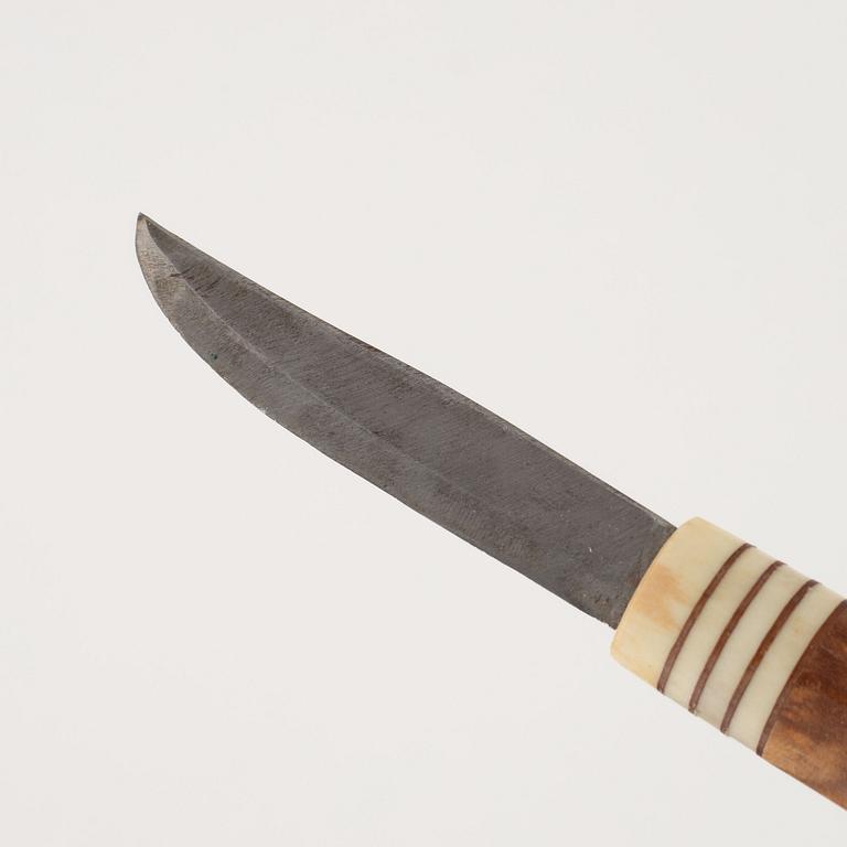 A reindeer horn knife, signed AL.