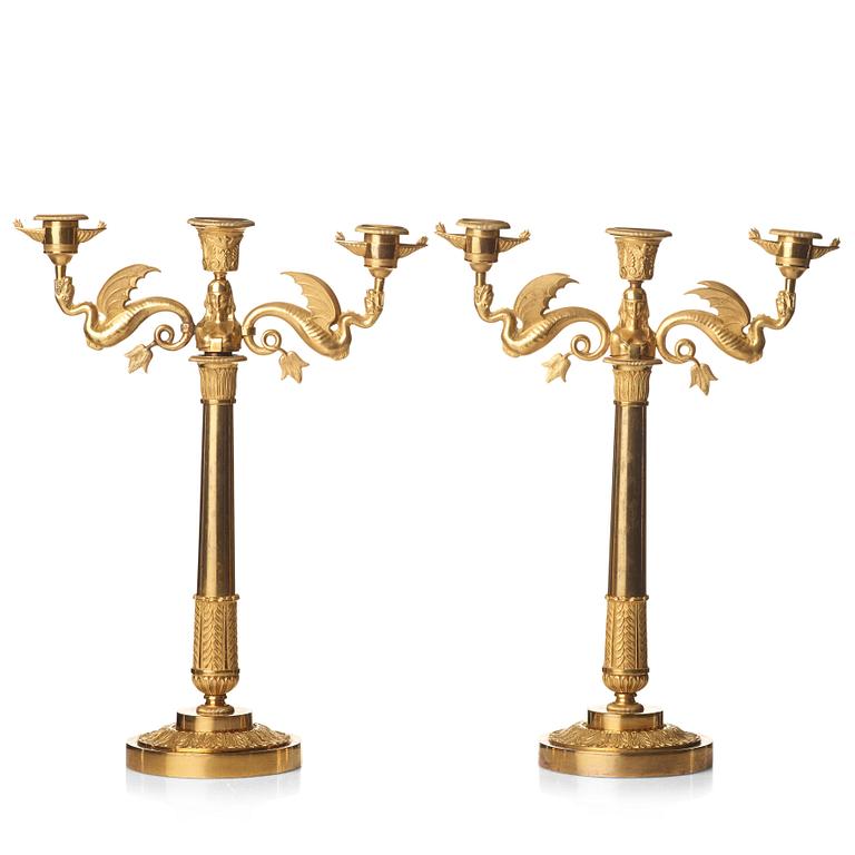 A pair of Empire early 19th century gilt bronze three-light candelabra.