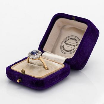 An 18K gold ring, with a sapphire and old-cut diamonds.