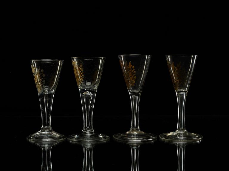 A set of four armorial wine goblets, 18th Century.