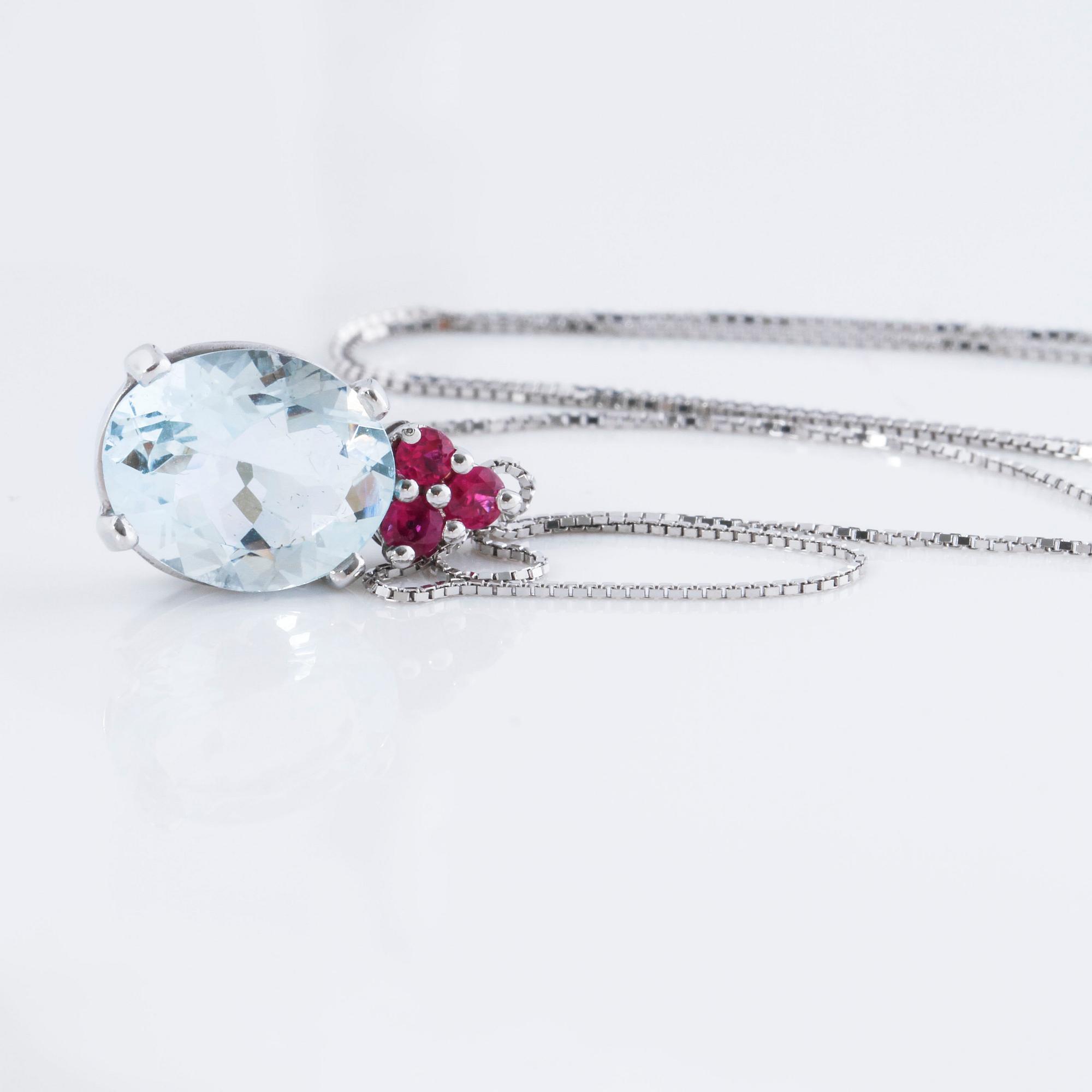 A aquamarine and ruby pendant.