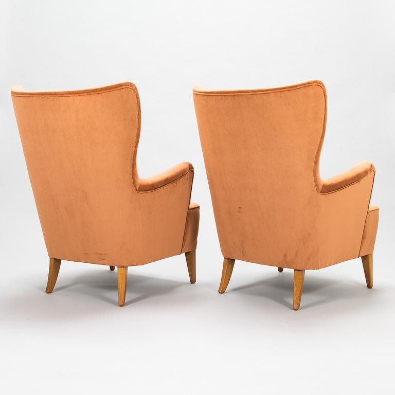 A pair of 1950's open arm chairs for Oy Paul Boman Ab.