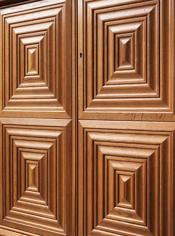 A Swedish Modern oak cabinet on stand attributed to Oscar Nilsson, 1940's.