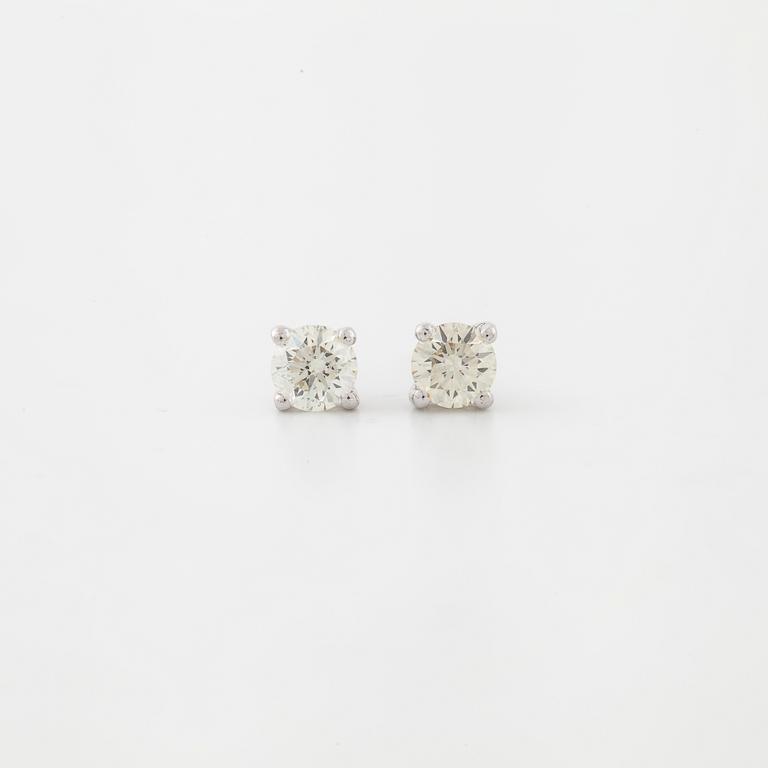 A pair of brilliant cut diamond earrings.