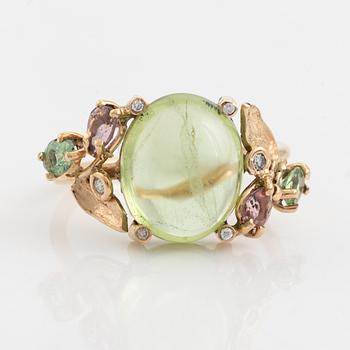Ring with cabochon-cut peridot, tourmaline, and small diamonds.