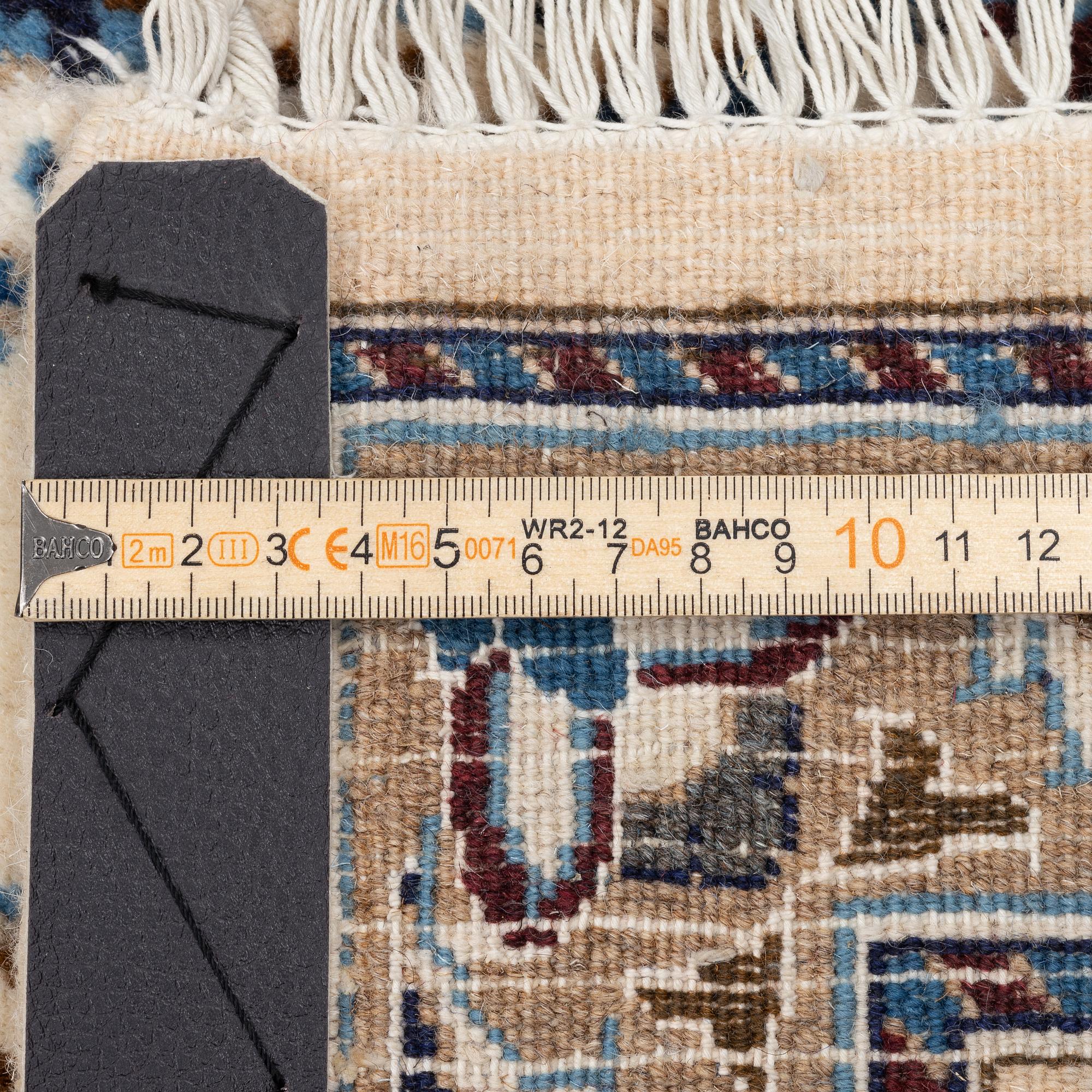 An Oriental carpet, approx. 354 x 243 cm.