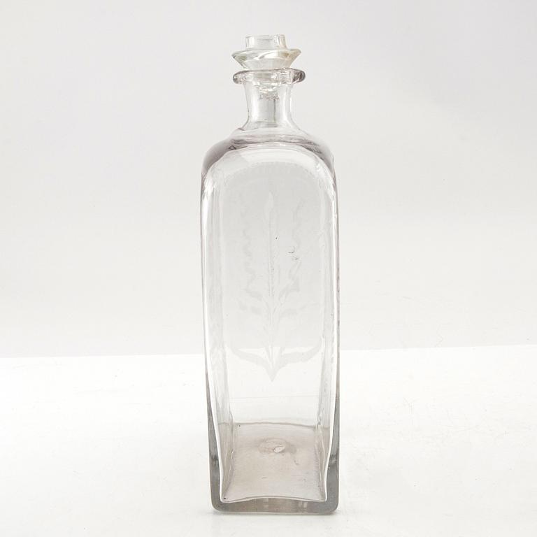 Brännvinsflaska, glas. Daterad Broby 1856.