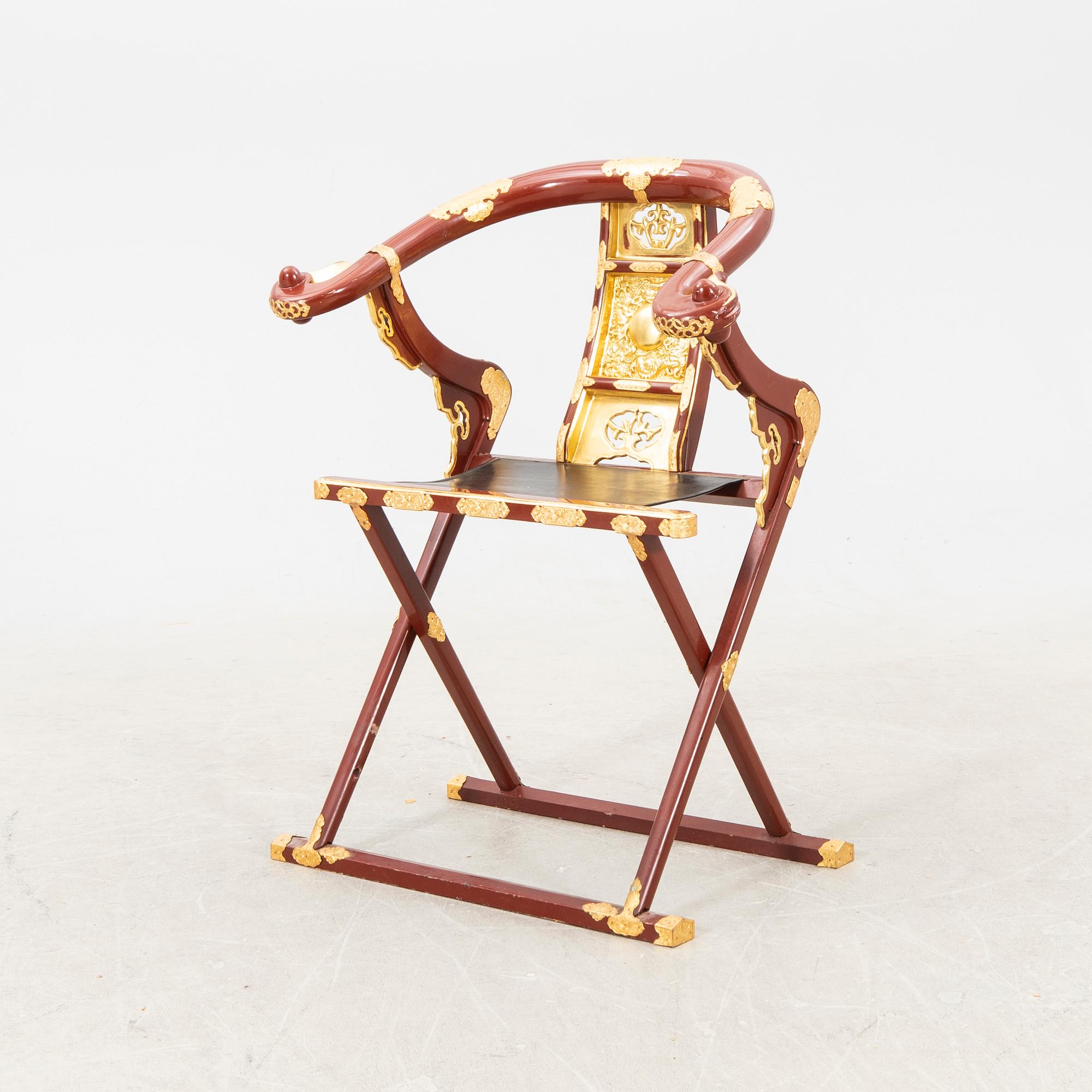A laqcuered wooden chair from China 21st century.