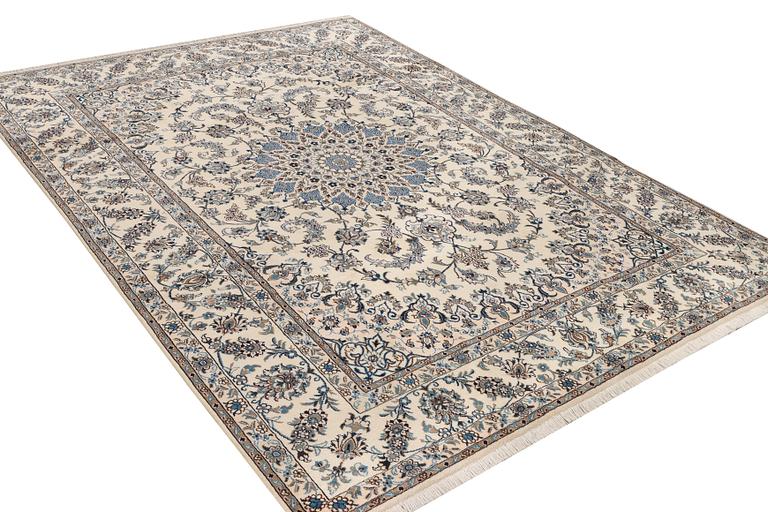 A Nain, part silk carpet, c. 337 x 244 cm.