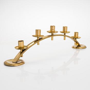 A mid-20th century brass candle holder, Idman.