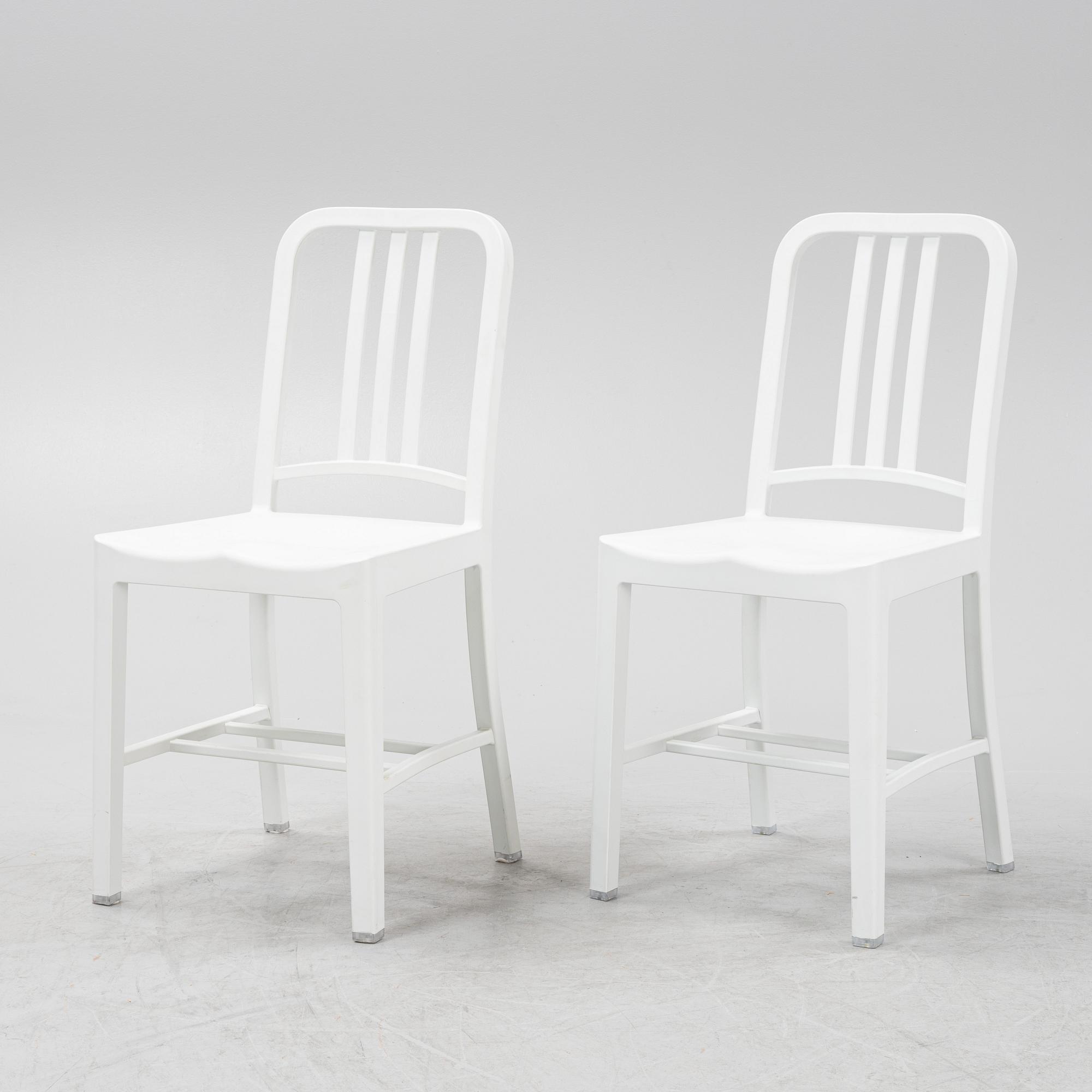 A pair of plastic 'Navy Chair' by Emeco.