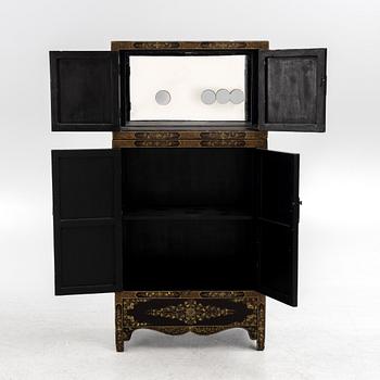 A Chinese lacquered two-part cabinet, first part of the 20th century.