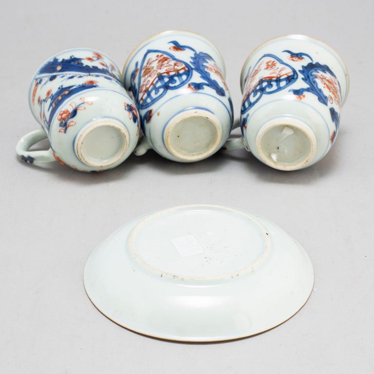 A pair of imari cups and a cup and saucer, Qing dynasty, 18th century.