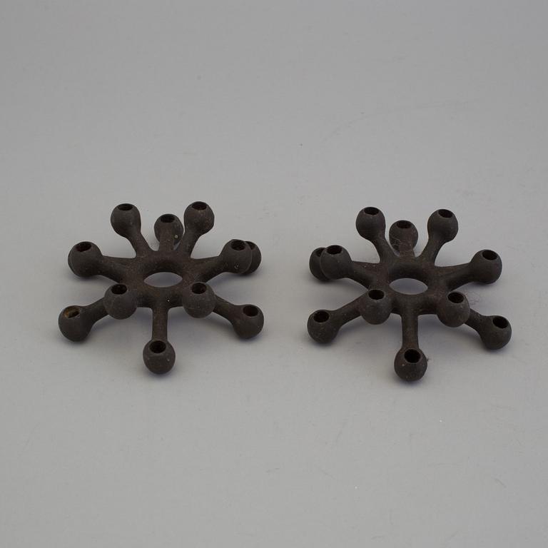4 different candlesticks, including Ystad Metall, "Nagel" by Werner Stoff.