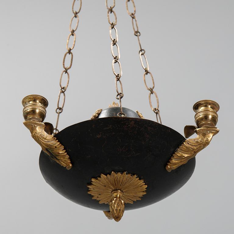 A Swedish Empire style 20th century three-light patinated brass hanging-lamp.