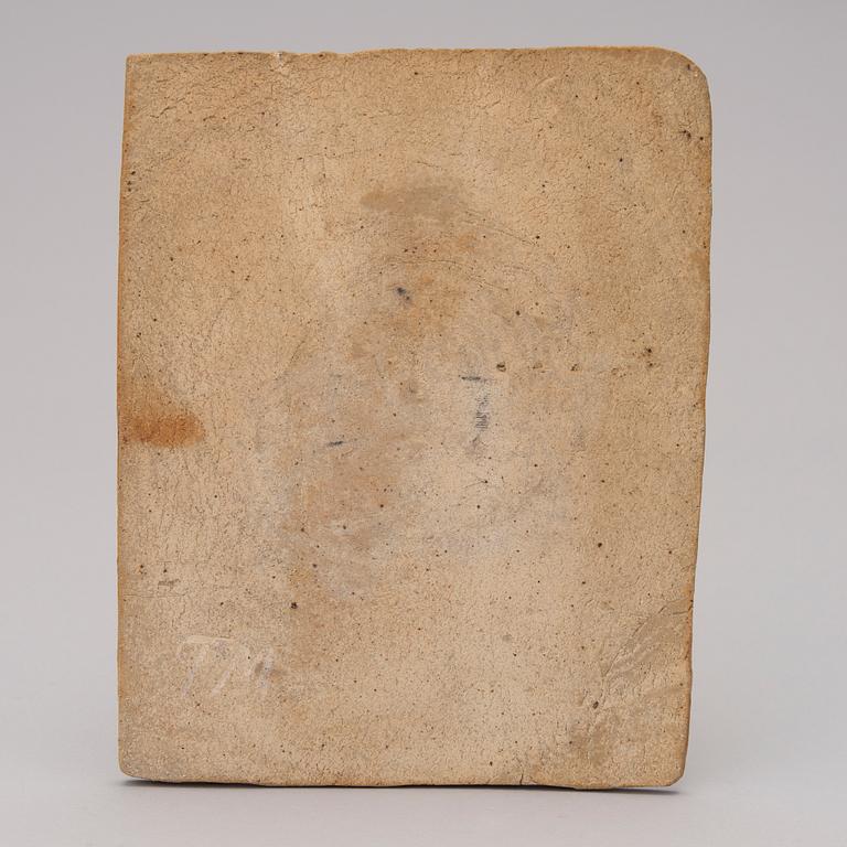 A stoneware art plate signed TM.