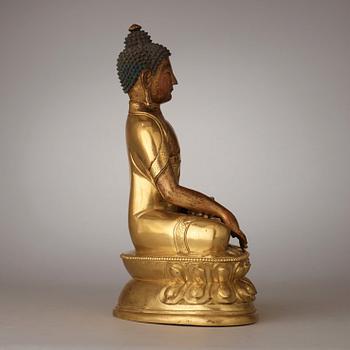 A finely cast Tibeto-Chinese gilt bronze figure of Shakyamuni Buddha, Qing dynasty, circa 1800.