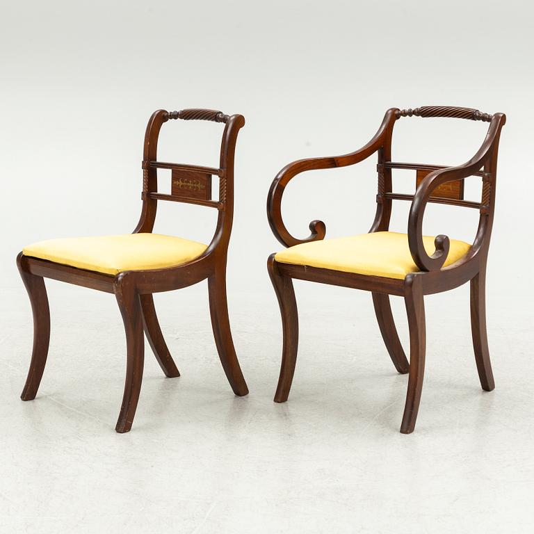 An Empire style dining table and ten chairs, second half of the 20th Century.